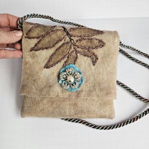 Felt bag with floral brooches